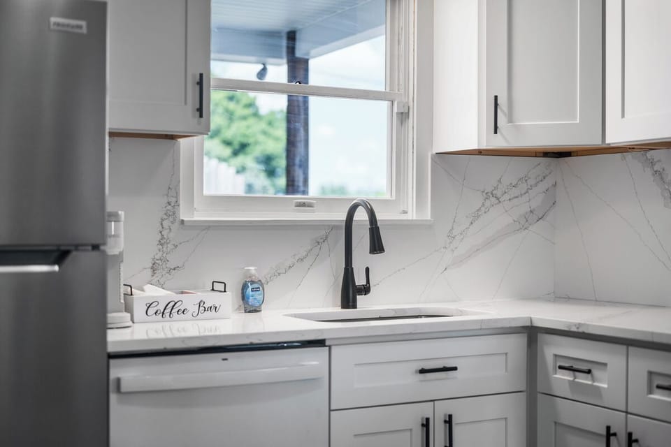 Bright modern kitchen with coffee bar, natural light, and sleek finishes