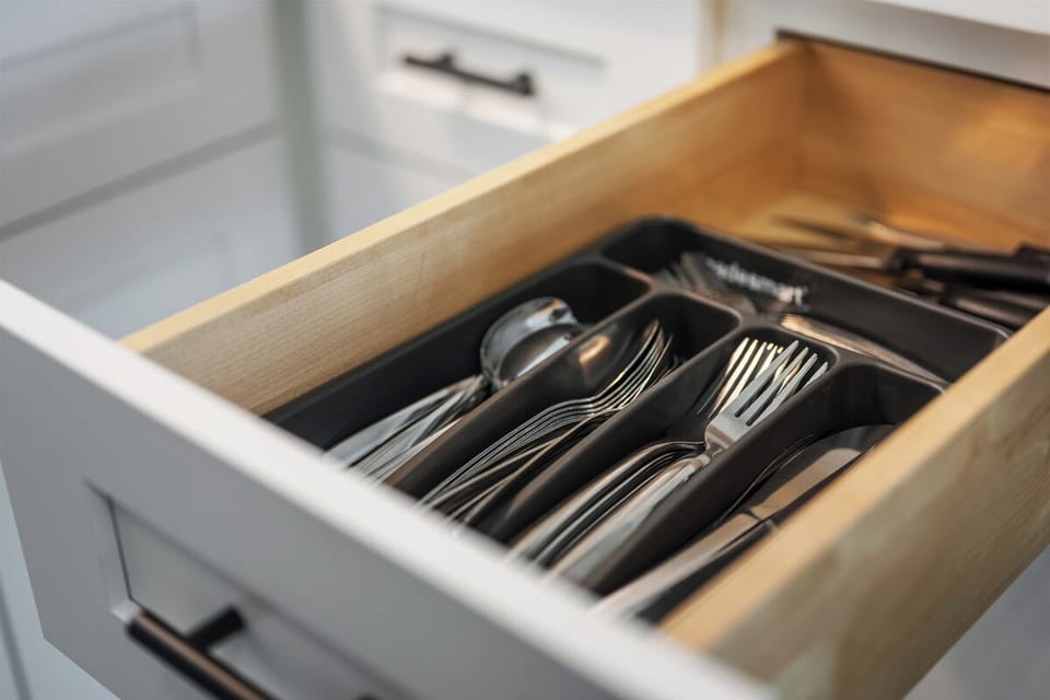 Organized kitchen drawer stocked with cutlery for easy guest dining