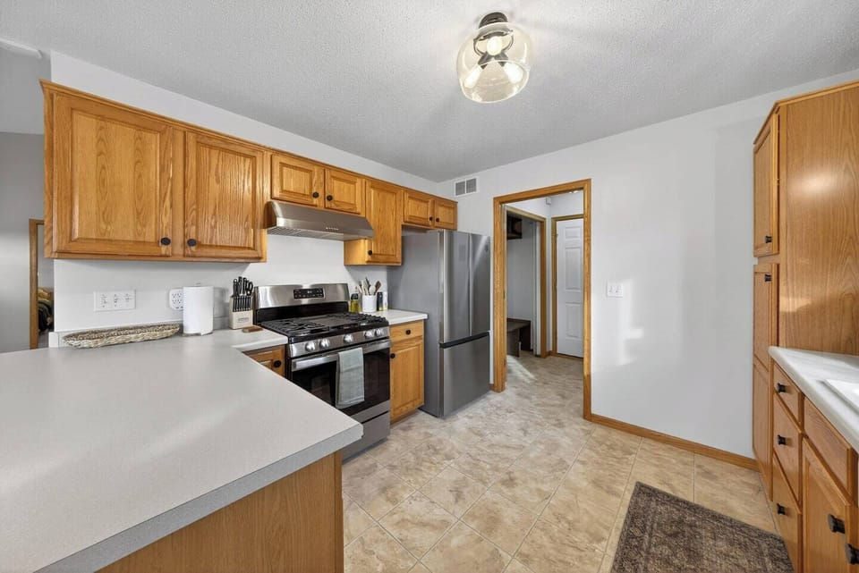 Full size kitchen that is fully stocked with a gas stove.