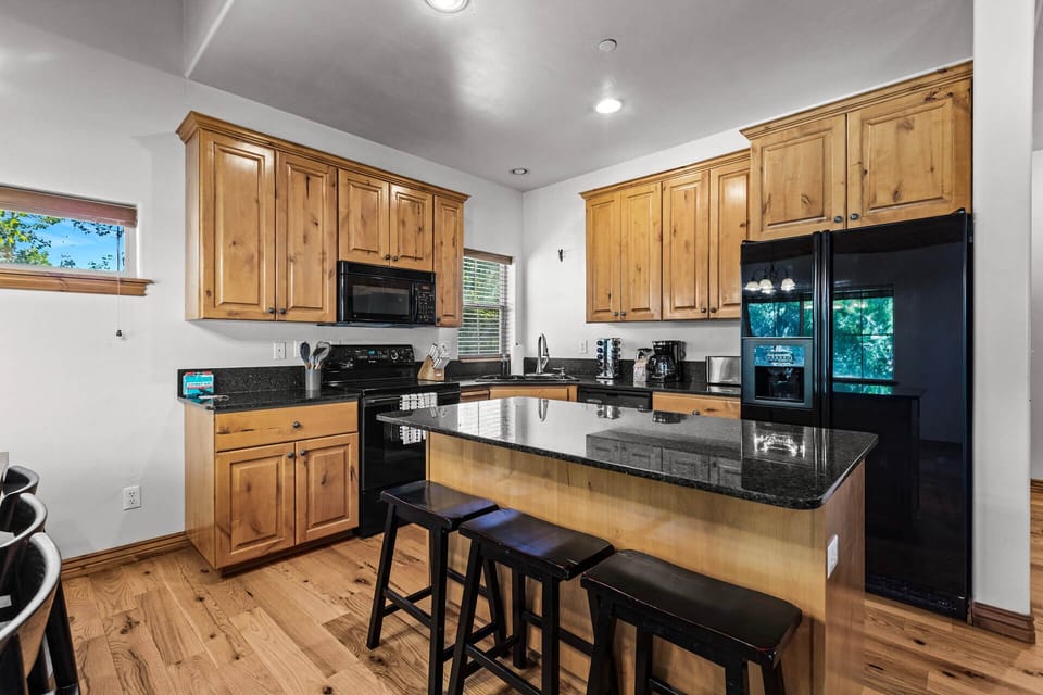 Your fully-equipped kitchen invites you to whip up delicious meals together, with sleek granite counters, modern appliances, and a handy breakfast bar for casual dining or morning coffee.
