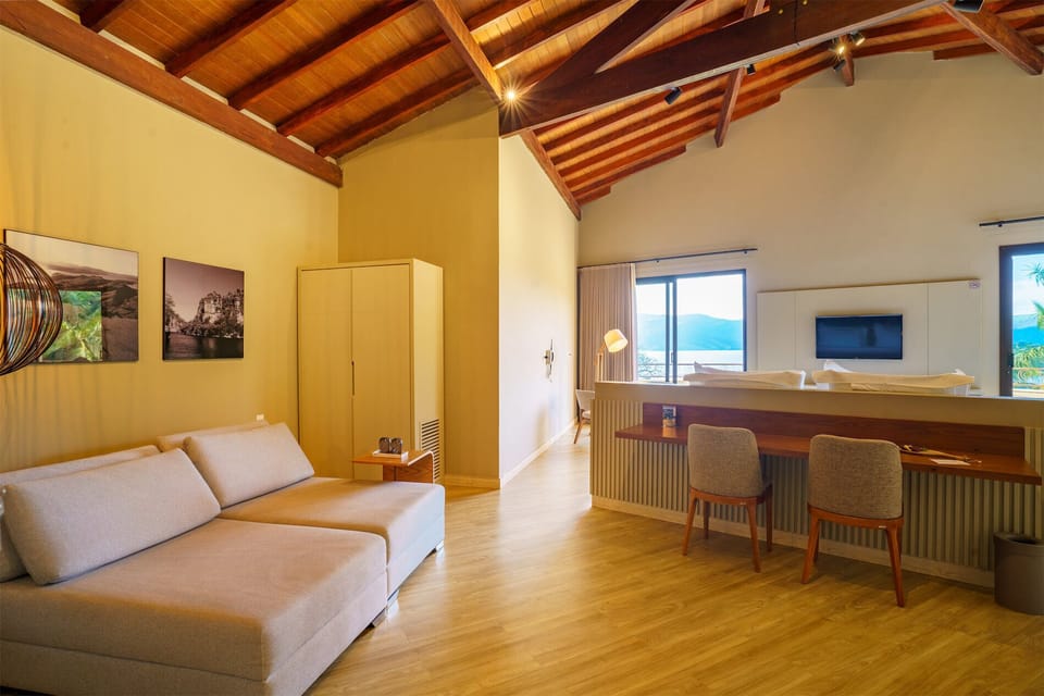 Luxury Suite, Lake View | Living area | 42-inch TV with cable channels