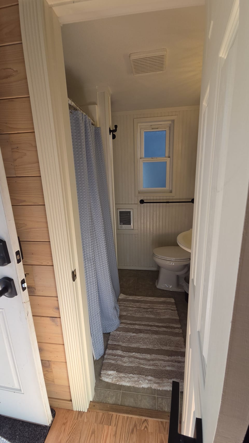 Bright, cozy bathroom with shower, natural light, and clean modern touches