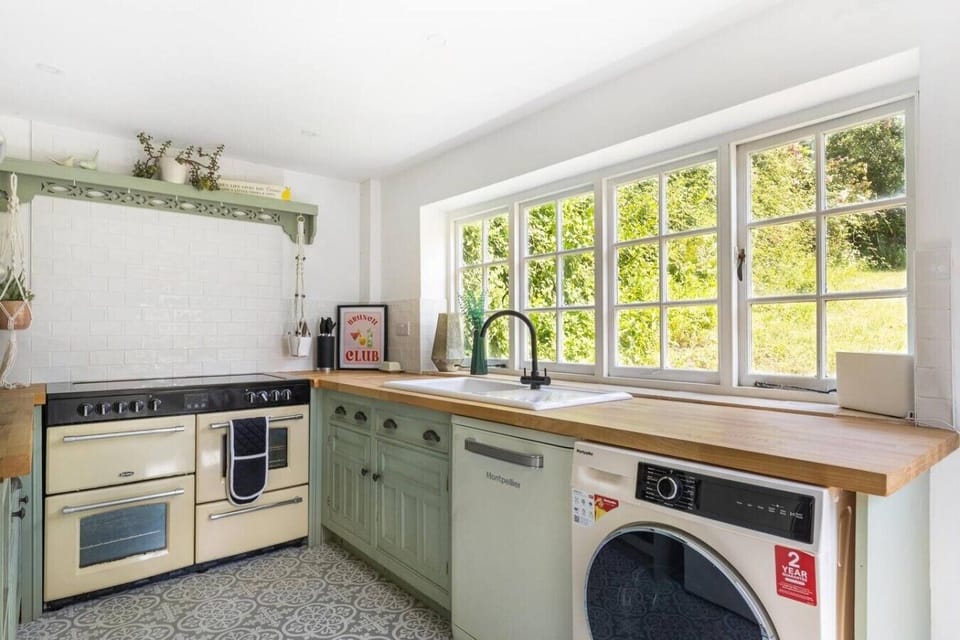 Country kitchen with range cooker and sunny garden window