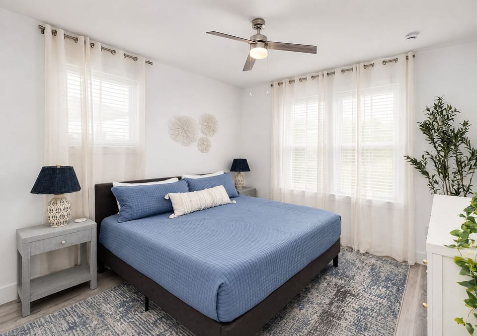 2nd Floor - King Suite #6 features a King bed, 55-inch 4K Smart TV, spacious layout, and private en-suite bathroom with a glass-enclosed walk-in shower.