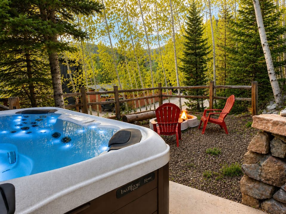 Private hot tub and cozy fire pit nestled in a peaceful forest setting