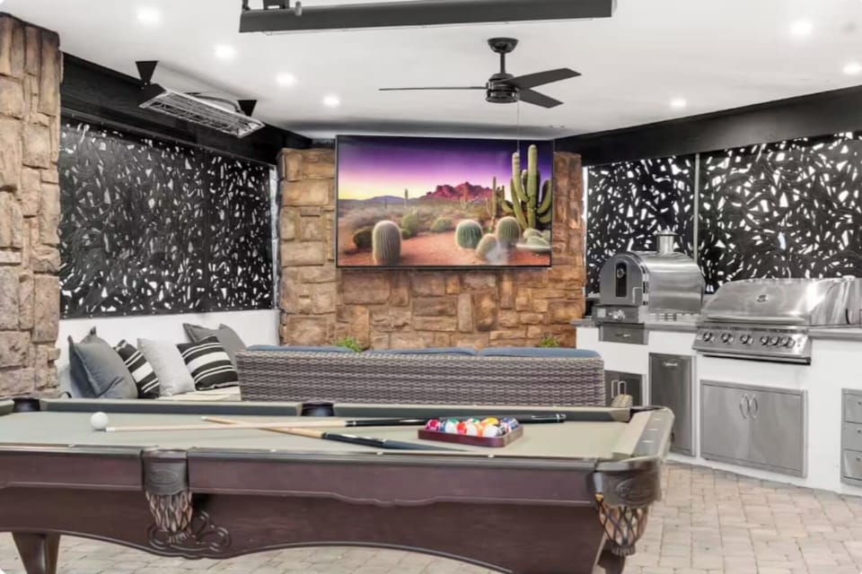 Decorative screen walls, a built-in grill, and a pool table make this covered lounge an entertainer's outdoor haven.