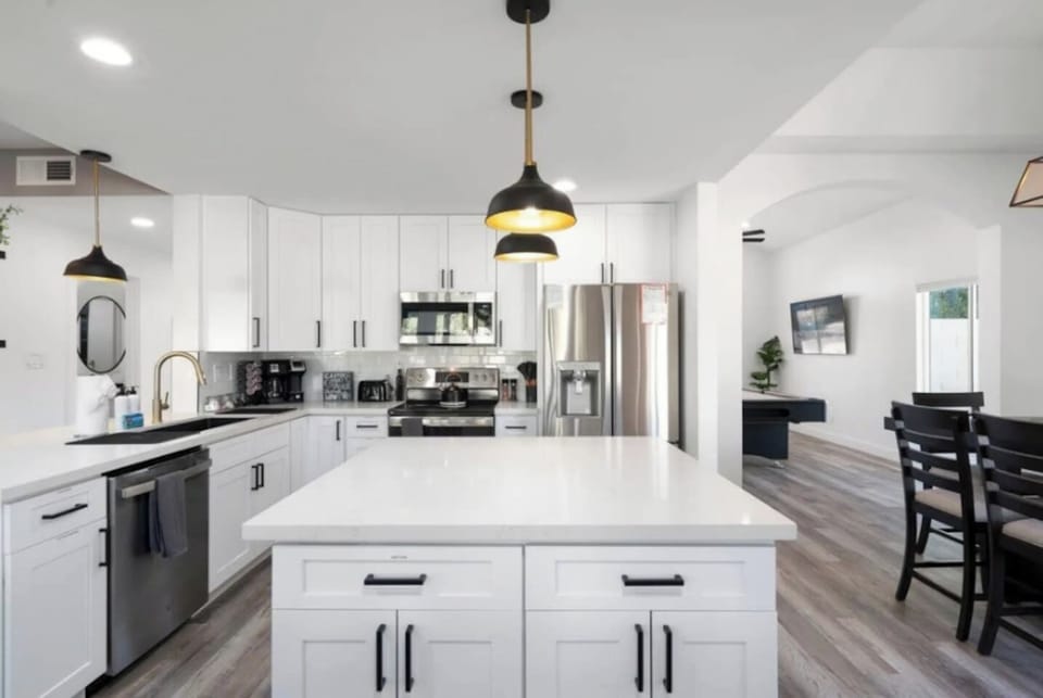 Chef's kitchen with stainless steel appliances, large island, and open floor plan perfect for cooking and entertaining.