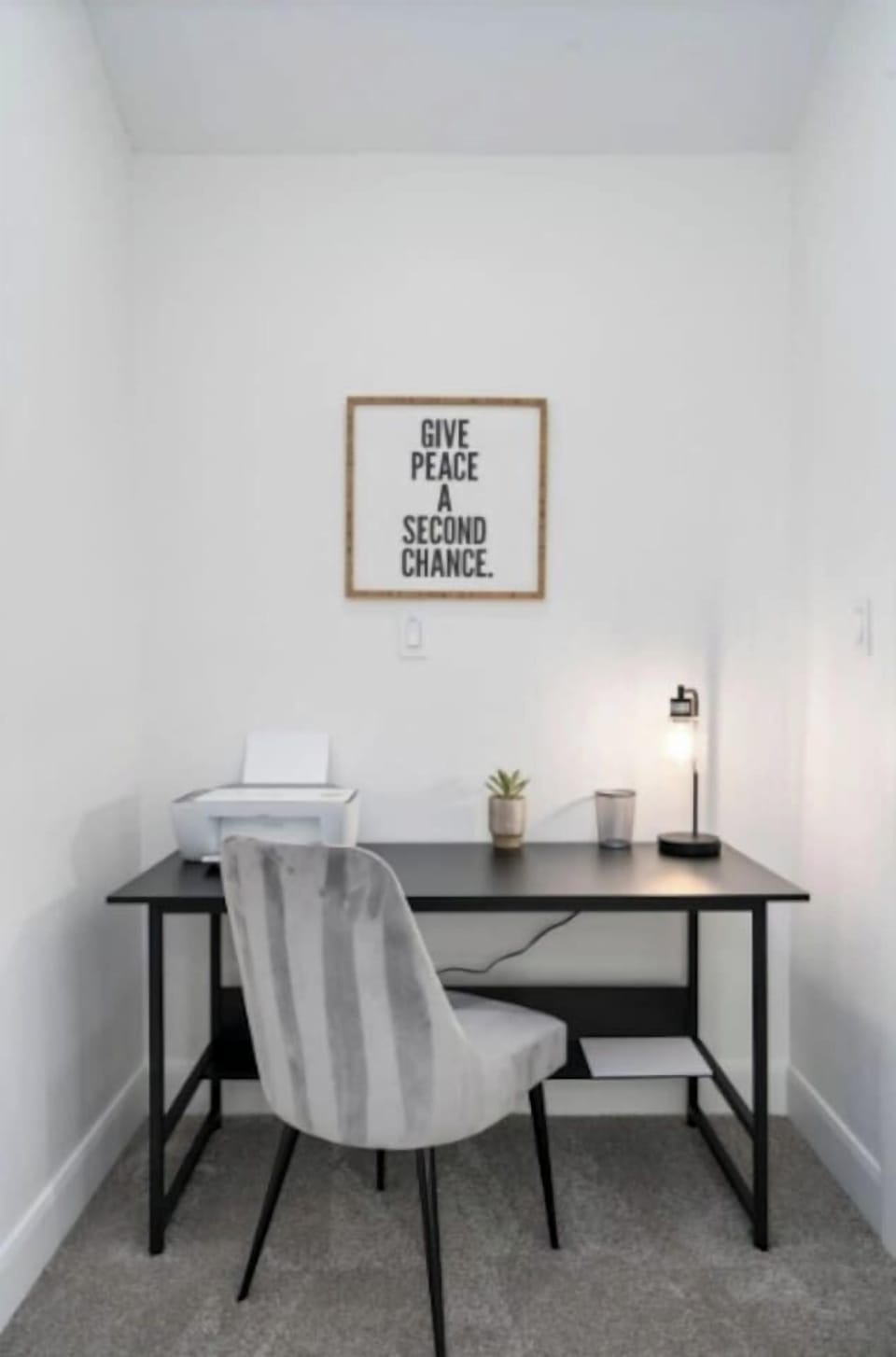 Dedicated office nook with desk, printer, and inspirational décor—perfect for remote work.