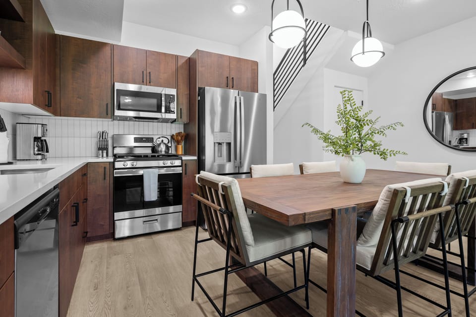 With its modern lighting, quartz countertops, and stunning backsplash, the kitchen makes preparing dinner a truly enjoyable experience.