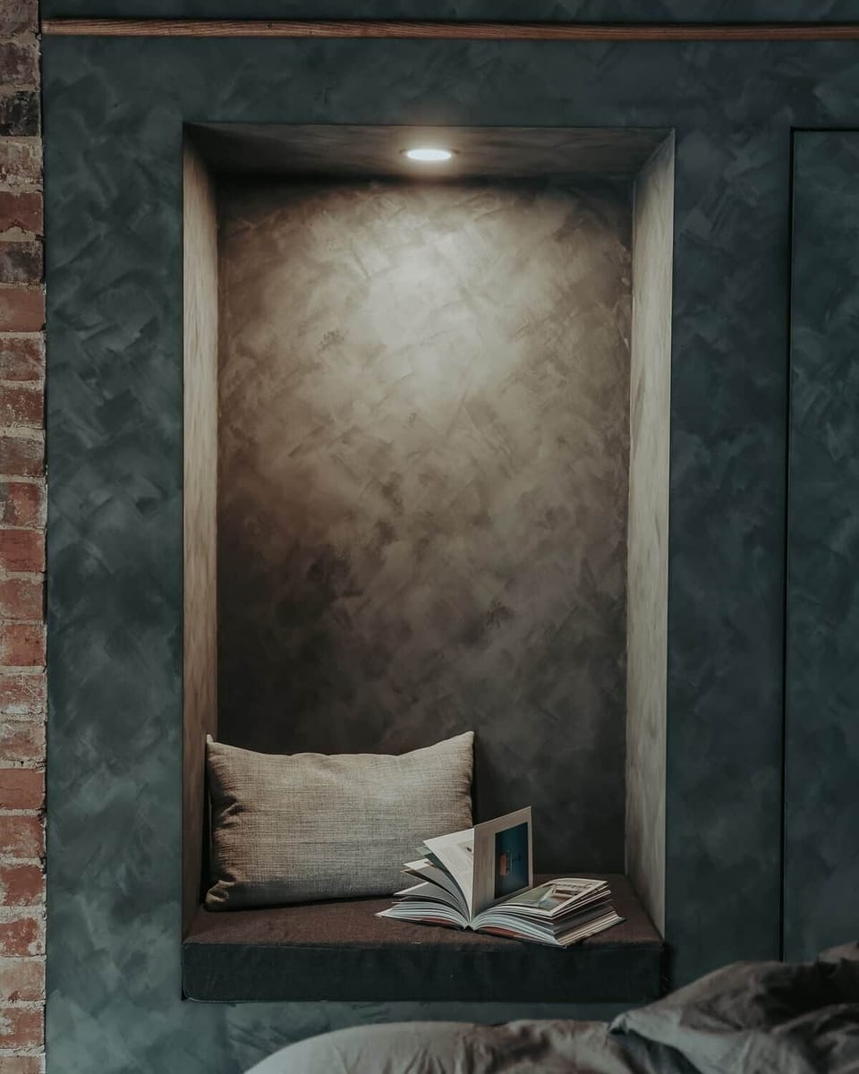 The lime-washed bedroom reading nook is the perfect place to curl up with a book. 
