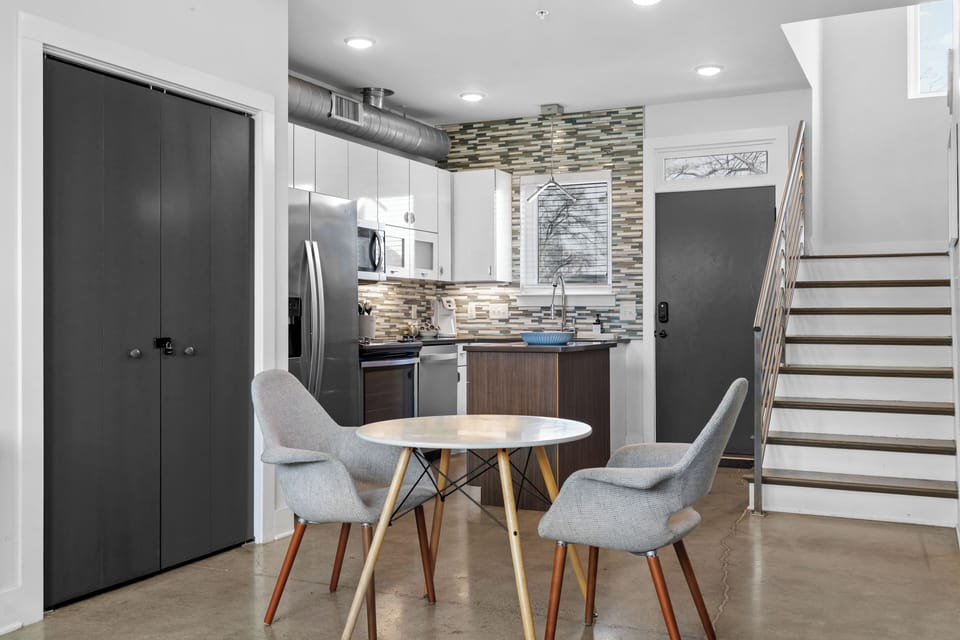 Modern kitchen with stainless appliances and a central island.