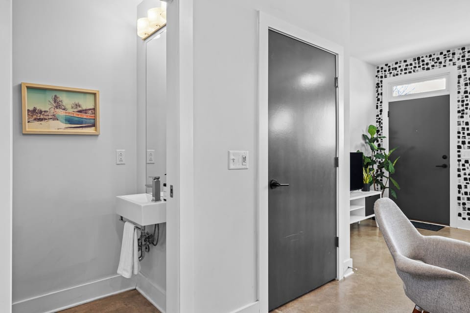 Modern half bathroom with a sleek wall-mounted sink.