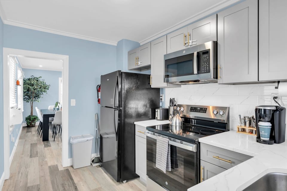 Bright modern kitchen with stainless appliances and dining room access