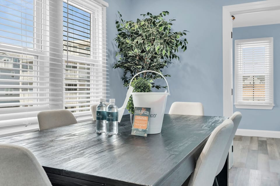 Bright, airy dining space with large windows and modern seating