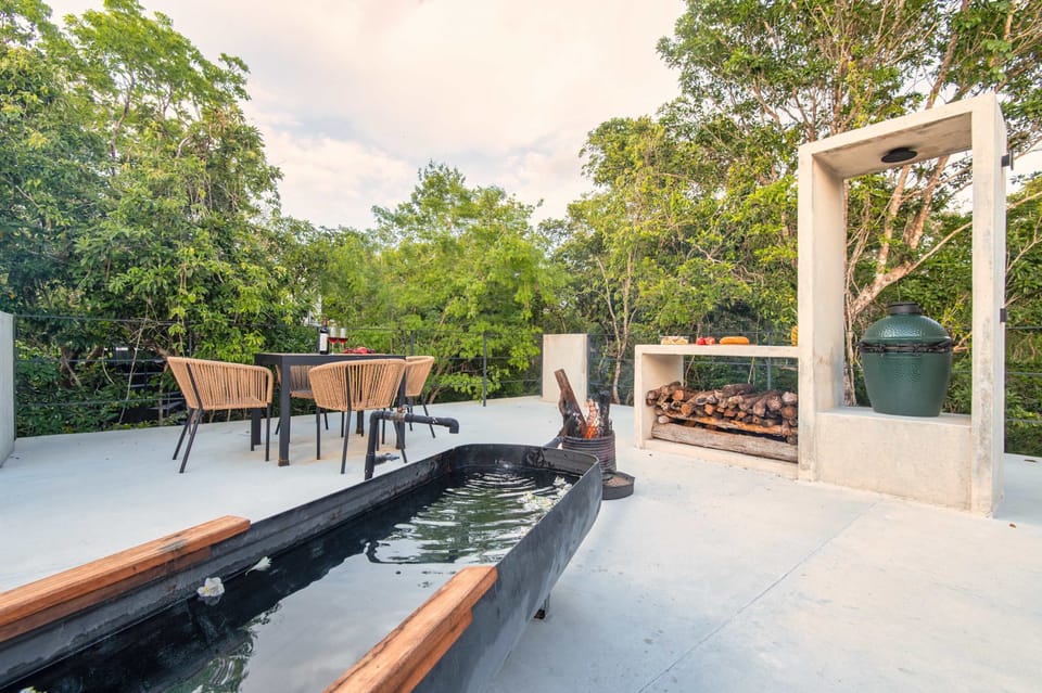 Private rooftop retreat: wood-fired hot tub, Big Green Egg grill, and jungle canopy views at every turn
