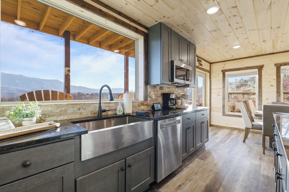 Modern mountain-view kitchen with farmhouse sink and cozy dining area