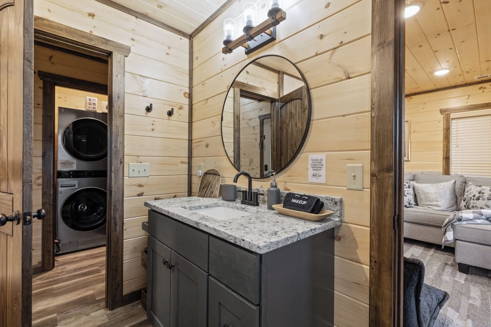Rustic-modern bath with granite vanity and in-unit washer/dryer