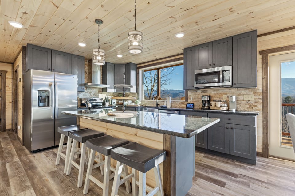 Spacious mountain-view kitchen with granite island and seating for four