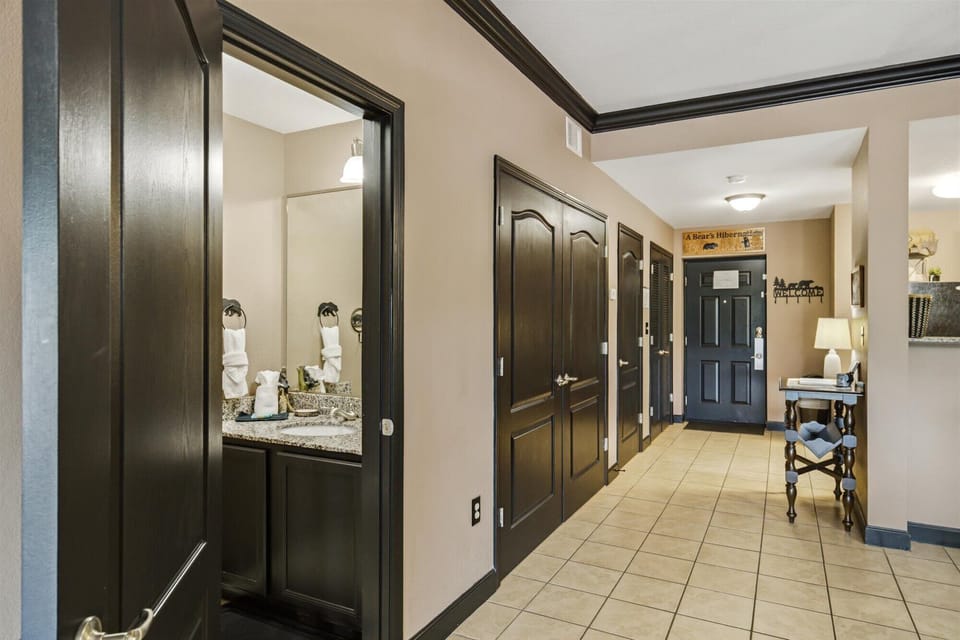 Welcoming tiled entryway with elegant dark wood finishes