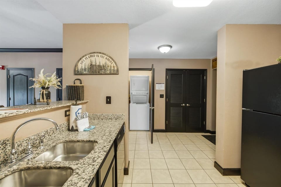 Granite kitchen with double sink and convenient in-unit washer/dryer