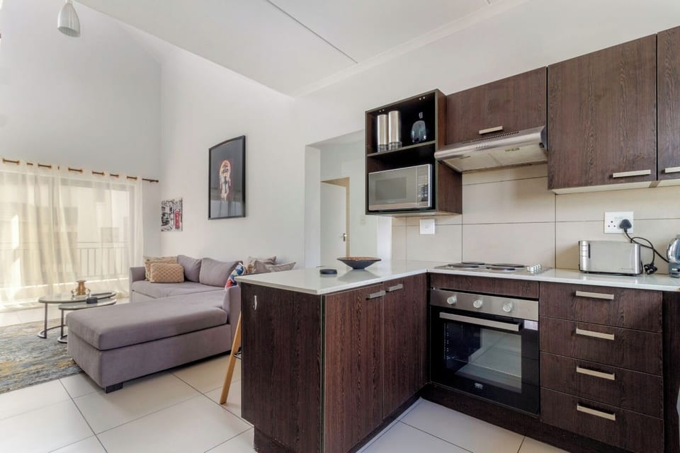 Sunny open-plan flat with sleek kitchen and cozy lounge area