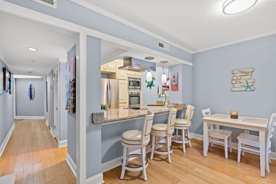 Coastal kitchen with granite bar, stainless appliances & dining nook