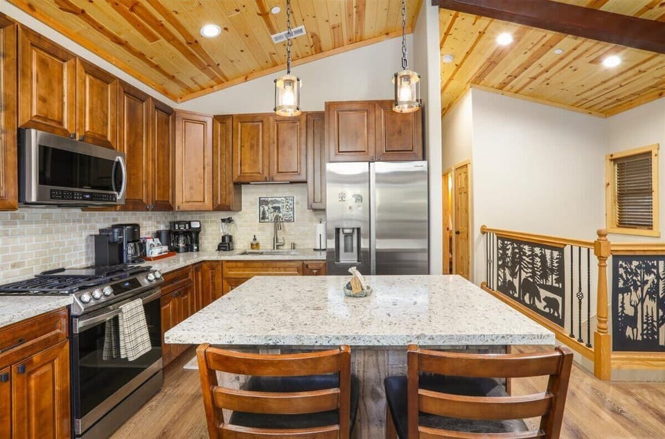 Fully equipped kitchen with gas range, large island and bar seating.