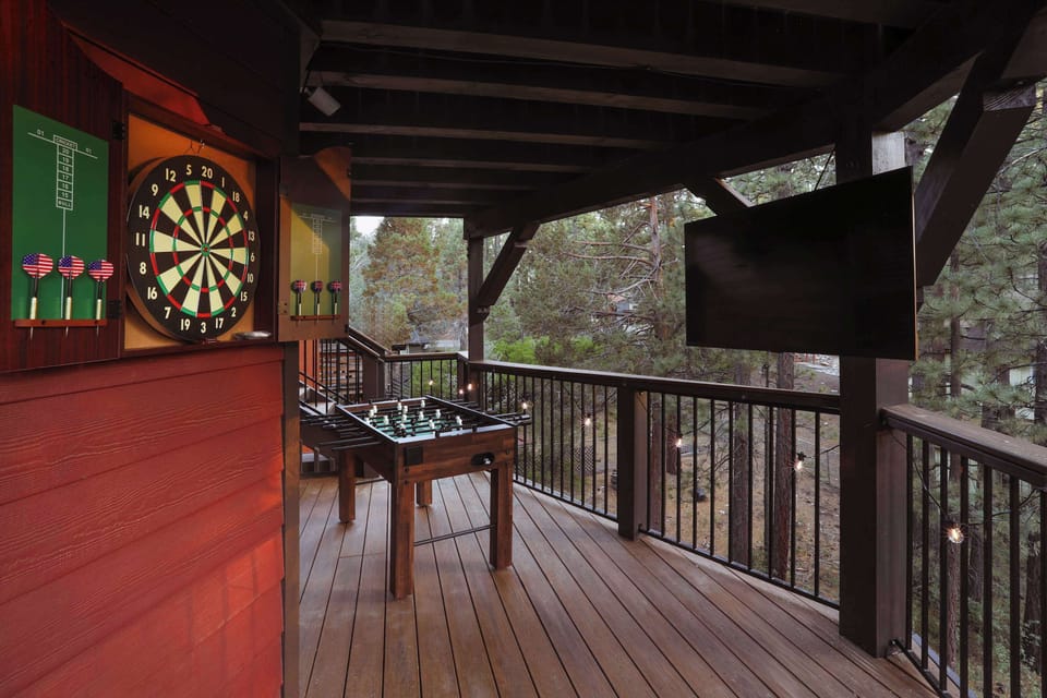 Game night continues outside with darts, foosball and a covered TV area.