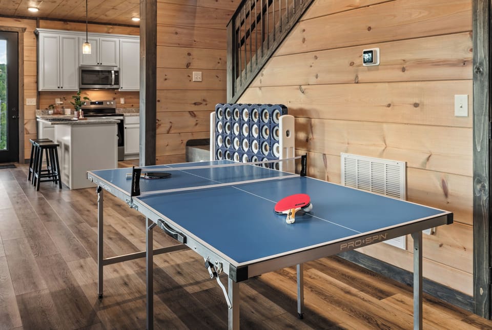 Rustic game space with ping pong table and open modern kitchen