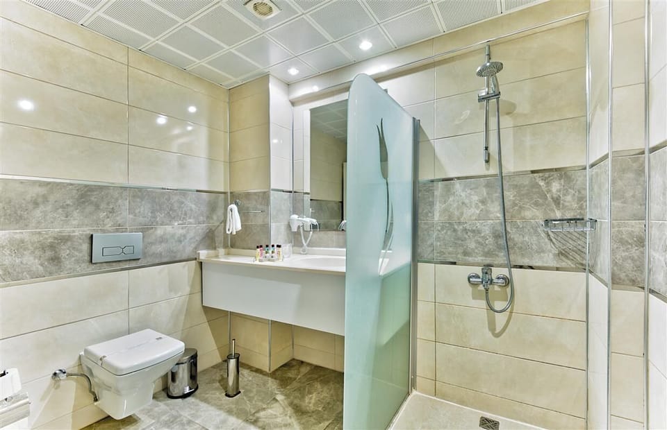 Shower, hair dryer, slippers, towels