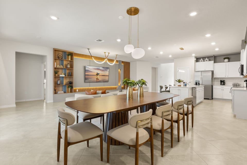 Elegant dining and kitchen area perfect for large gatherings, featuring modern decor and ample seating for a memorable stay.