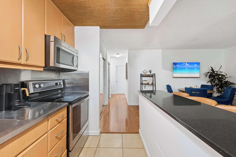Fully equipped kitchen featuring stainless steel appliances, pristine countertops, and all the essentials needed for home-cooked meals