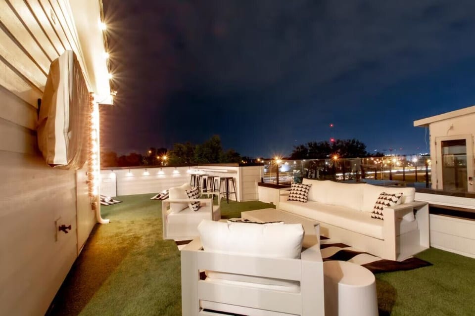 Unwind under the open sky on this spacious rooftop patio equipped with luxury outdoor lounge furniture.