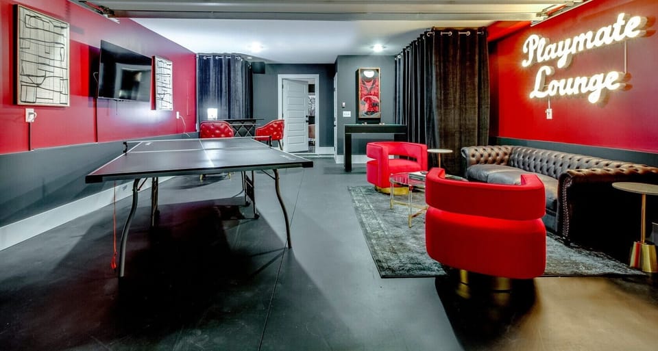 Sleek game room featuring a ping pong table, bold accents, and plenty of space for friendly group competition.