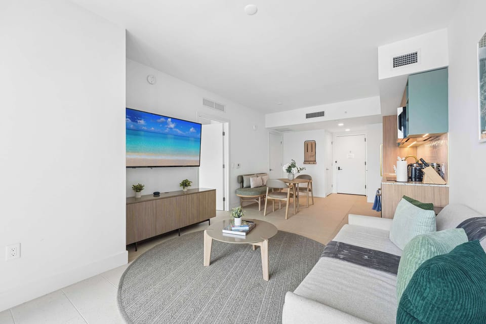 Bright living room setup  with a smart tv and a sofa bed 