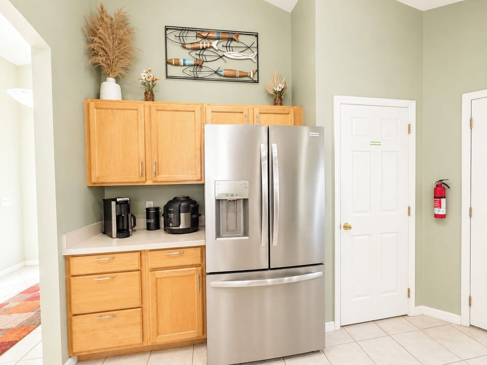 Kitchen showing refrigerator and coffee area.
