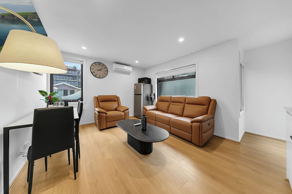 Bright modern lounge with leather seating and dining nook