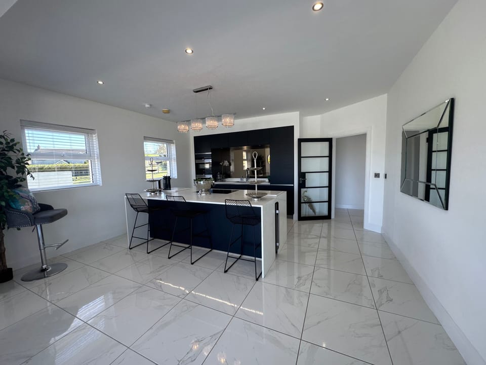 One of the two kitchens. Featuring a quooker tap and bora oven. Integrated oven, micro, dishwasher and fridge along with wind cooler