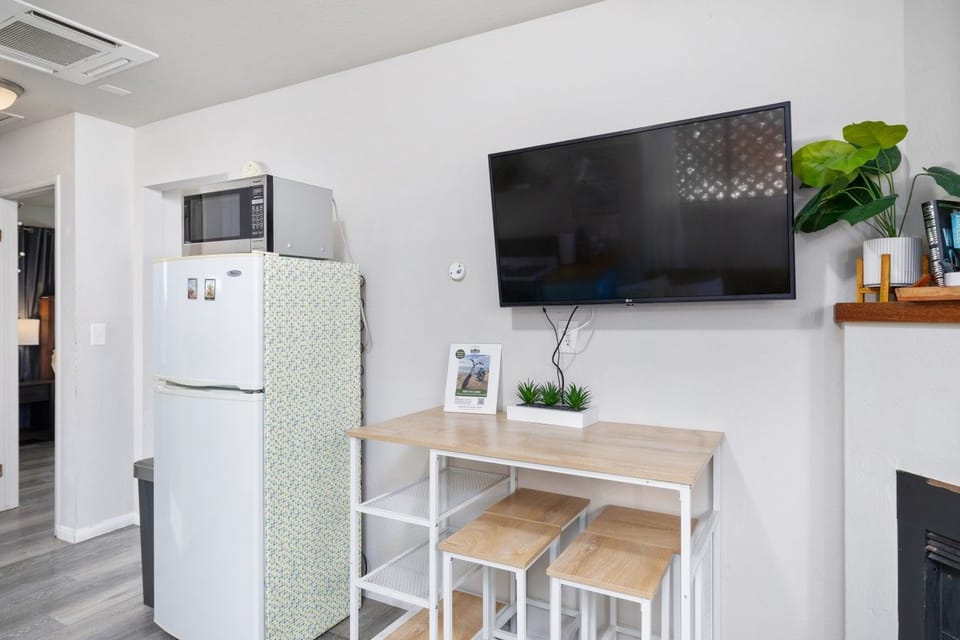 Bar-style dining area with seating for two, conveniently located beside the kitchen.