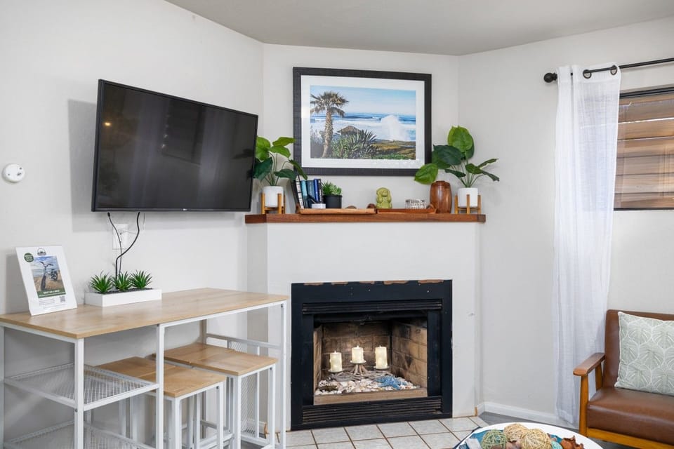 Living area with a Smart TV and bar-style seating for dining or working.