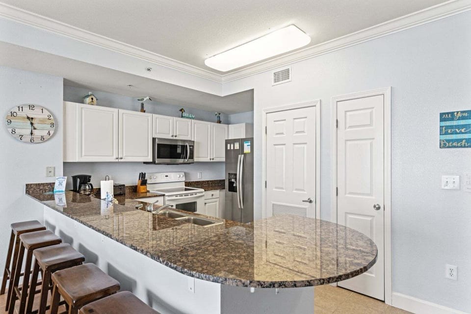Full kitchen with all the cooking essentials and breakfast bar with ample seating