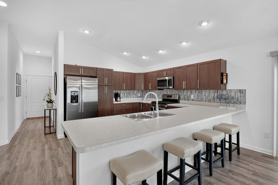 Spacious Kitchen with a Breakfast Bar and Seating for 4x.  Foyer to the Left