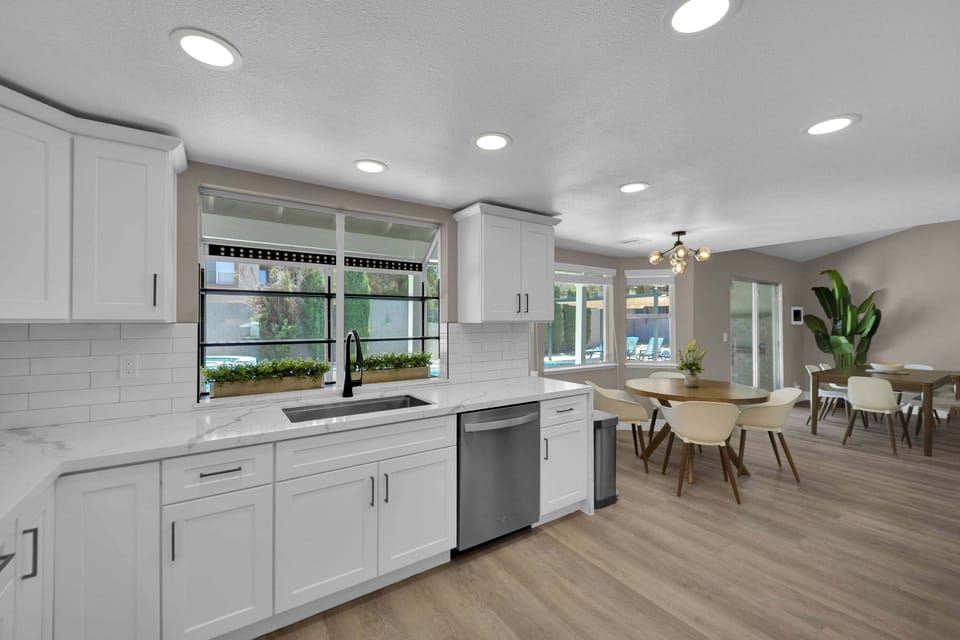 Premium stainless steel appliances, a 36-inch gas cooktop, built-in oven and microwave, and a charming breakfast nook that flows seamlessly into the dining and living areas.