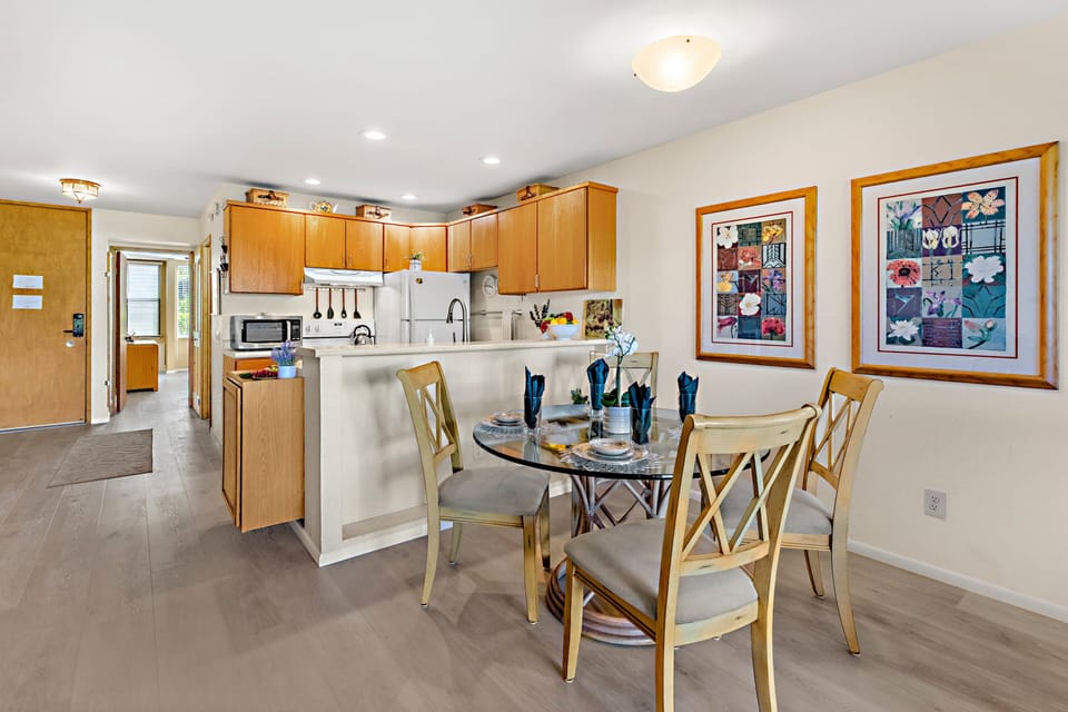 The dining area flows effortlessly into the fully equipped kitchen.