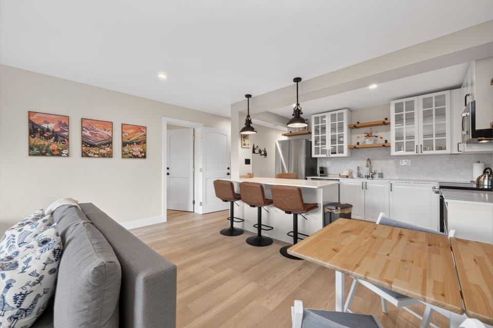 Bright, open-concept living with natural light and sleek hardwood floors. Gather at the kitchen island while friends relax nearby—everything flows effortlessly in this modern, welcoming retreat.