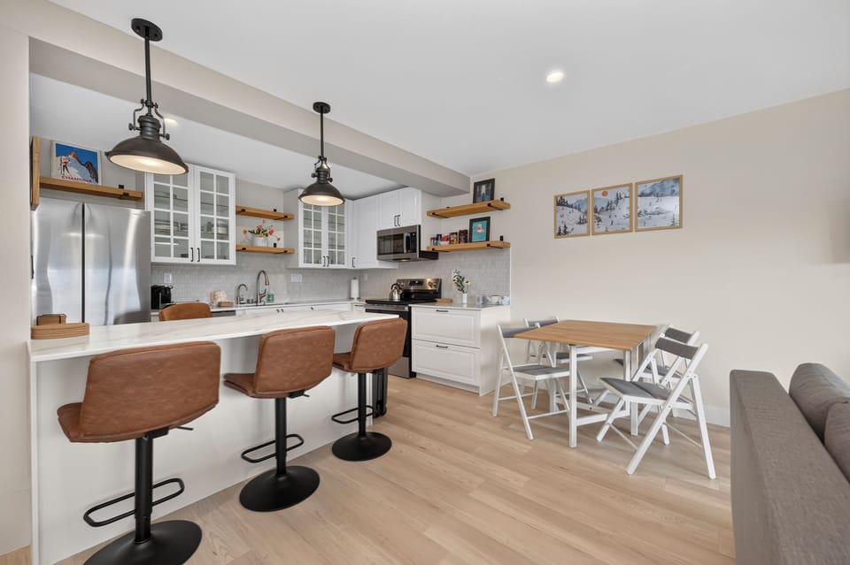 Your open-concept kitchen and dining area invites effortless gatherings, with gleaming countertops, modern appliances, and a breakfast bar where morning coffee tastes better.