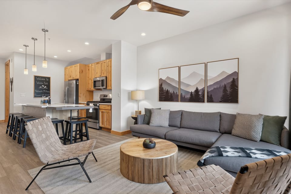 Unwind in your spacious open-concept retreat, where mountain artwork, cozy seating, and a fully-equipped kitchen blend seamlessly. Light, airy, and thoughtfully designed for your comfort.
