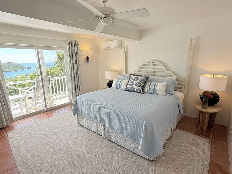 The pool level primary bedroom  opens to a covered balcony, a perfect spot to relax 