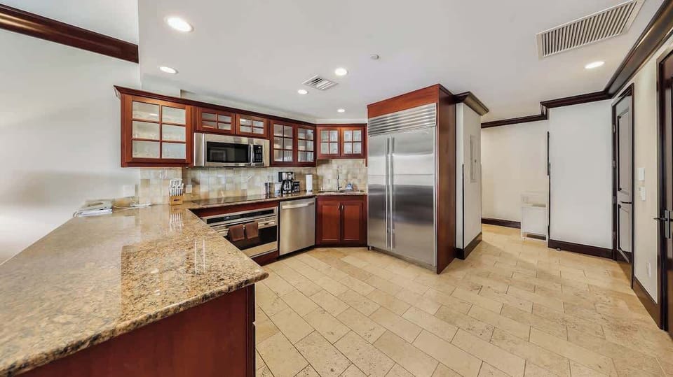 Your spacious kitchen awaits, featuring granite countertops, stainless steel appliances, and elegant cabinetry—perfect for preparing memorable meals together.