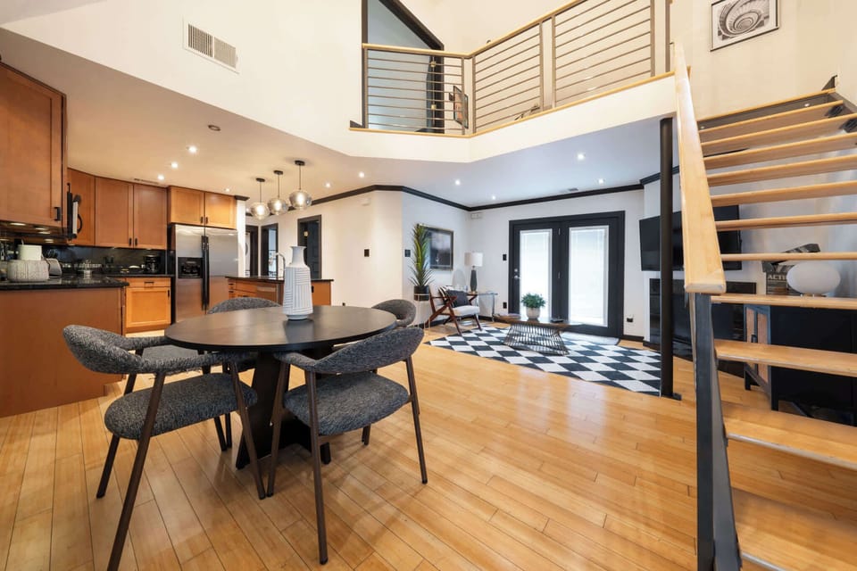 Spacious open-concept living area with modern kitchen and stylish decor, perfect for relaxing and entertaining.